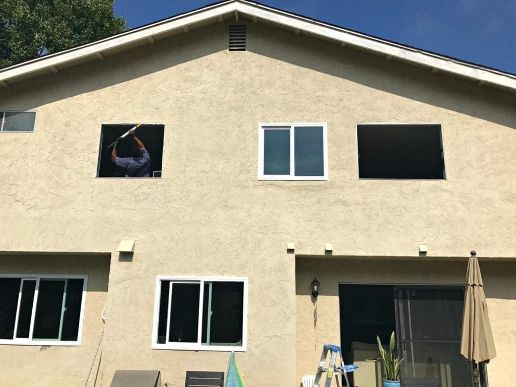 Before and after photos of our window replacement home improvement project. Not a DIY job for us but worth every penny of the cost. We went with vinyl windows instead of wood, and replaced the slider and screen instead of putting in french doors. Read the five biggest lessons we learned. #homeimprovement #diyproject #windows #interiordesign #investment #homedecor #beforeandafter 