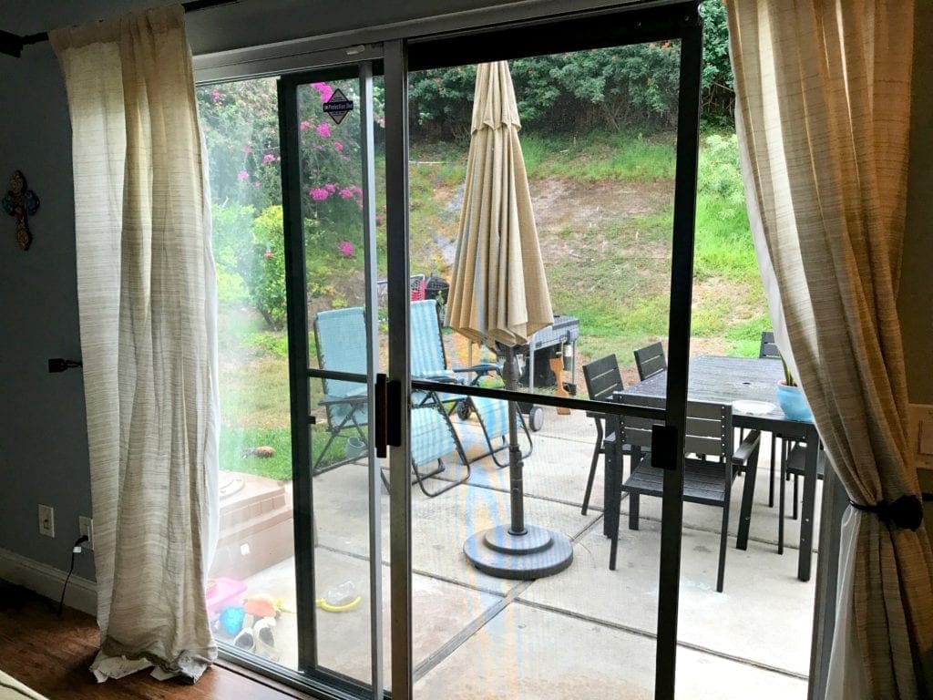 Before and after photos of our window replacement home improvement project. Not a DIY job for us but worth every penny of the cost. We went with vinyl windows instead of wood, and replaced the slider and screen instead of putting in french doors. Read the five biggest lessons we learned. #homeimprovement #diyproject #windows #interiordesign #investment #homedecor #beforeandafter
