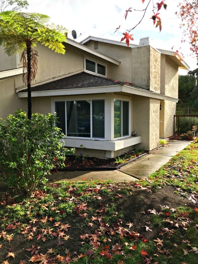 Before and after photos of our window replacement home improvement project. Not a DIY job for us but worth every penny of the cost. We went with vinyl windows instead of wood, and replaced the slider and screen instead of putting in french doors. Read the five biggest lessons we learned. #homeimprovement #diyproject #windows #interiordesign #investment #homedecor #beforeandafter 