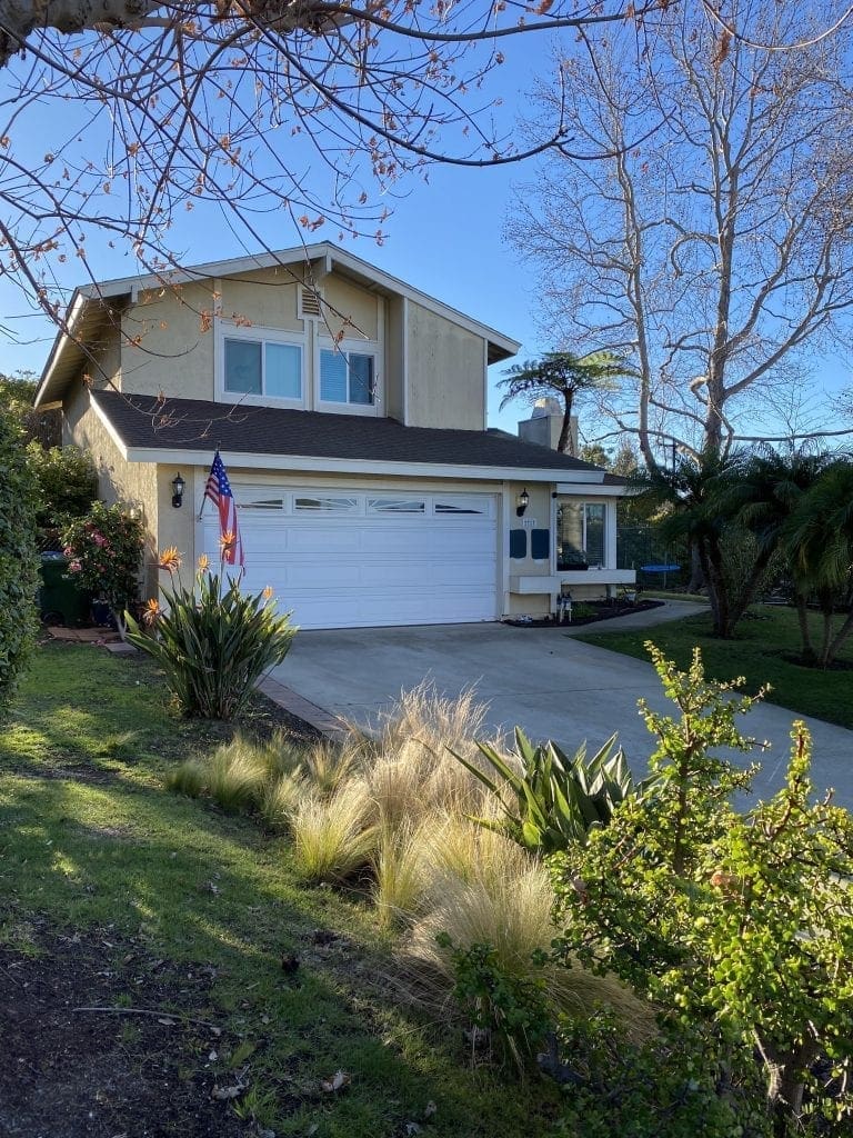 Exterior house paint before painting contractors started. View from street. 